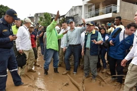 Tổng thống Colombia Juan Manuel Santos (giữa, phía trước) thị sát khu vực lở đất và chỉ đạo công tác khắc phục thảm họa ngày 1/4 vừa qua. (Ảnh: THX/TTXVN)