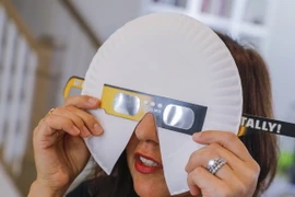 Người dân dùng kính để quan sát hiện tượng nhật thực toàn phần ở Decatur, Georgia, Mỹ ngày 20/8. (Ảnh: EPA/TTXVN)