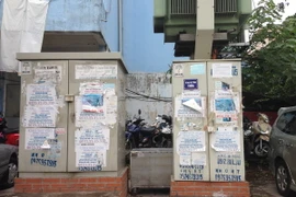 Quảng cáo dán tại các điểm công cộng gây mất mỹ quan đô thị. (Ảnh: Nguyễn Thắng/TTXVN)