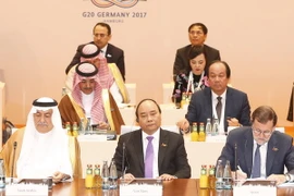 Thủ tướng Nguyễn Xuân Phúc dự phiên họp thứ 3 về chủ đề Quan hệ đối tác với châu Phi, Di cư và Y tế tại Hội nghị G-20. (Ảnh: Thống Nhất/TTXVN)