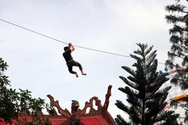 Khách du lịch chơi đu dây ở Công viên chủ đề lớn nhất Việt Nam, hàng đầu Châu Á tại đảo ngọc Phú Quốc (Kiên Giang). (Ảnh: Lê Huy Hải/TTXVN)