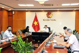 Bộ trưởng Nguyễn Hồng Diên điện đàm với một số doanh nghiệp sản xuất ở các tỉnh phía Nam để nắm bắt tình hình sản xuất kinh doanh. (Ảnh: PV/Vietnam+)