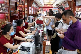 Khách hàng giao dịch vàng miếng. (Ảnh: TTXVN)