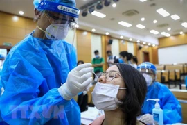 Tổ chức xét nghiệm sàng lọc COVID-19 cho người dân. (Ảnh: TTXVN)
