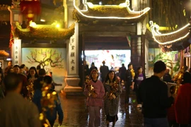 Sau thời khắc chuyển giao giữa năm cũ và năm mới, rất đông người dân Hà Nội đến chùa Hà (Cầu Giấy, Hà Nội) để thắp hương, lễ phật, xin lộc, cầu mong năm mới an lành. (Ảnh: Minh Sơn/Vietnam+)