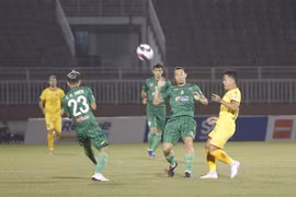 Pha tranh bóng giữa các cầu thủ đội chủ nhà Sài Gòn FC (áo xanh) và SLNA (áo vàng). (Ảnh: Thanh Vũ/TTXVN)