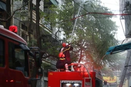 Lính cứu hỏa đang nỗ lực dập tắt đám cháy. (Ảnh: Huy Hùng/TTXVN)