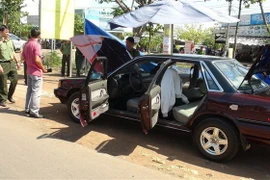 Lực lượng chức năng rà mìn trên xe ôtô của ông Hữu. (Ảnh: Đậu Tất Thành/TTXVN)