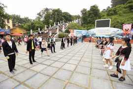 Các chàng trai cô gái chơi ném pa pao, trò chơi truyền thống của người Mông. (Ảnh: Xuân Tư/TTXVN)