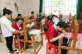 Lớp học tại Trung tâm dạy nghề người khuyết tật. (Ảnh: Anh Tuấn/TTXVN)