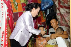 Chủ tịch Quốc hội Nguyễn Thị Kim Ngân đến thăm, tặng quà các hộ dân thuộc dự án di dời dân ở phường Thuận Lộc, thành phố Huế. (Ảnh: Trọng Đức/TTXVN)