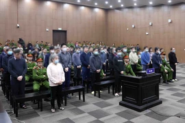 Các bị cáo nghe toà tuyên án. (Ảnh: Phạm Kiên/TTXVN)