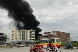 Đám khói đen kịt từ vụ cháy bốc cao hàng chục mét. (Ảnh: Thái Hùng/TTXVN)