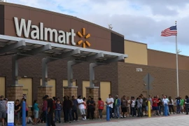 Người dân xếp hàng bên ngoài cửa hàng Walmart ở Houston, Texas, Mỹ. (Ảnh: AFP/TTXVN)