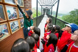 Các em học sinh tham quan, tìm hiểu tại Cơ sở bảo tồn gấu Ninh Bình. (Ảnh: Thùy Dung/TTXVN)