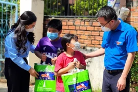 Đoàn viên, thanh niên Thành phố Hồ Chí Minh thăm hỏi, tặng quà cho con công nhân có hoàn cảnh khó khăn, người lao động tại các khu nhà trọ. (Ảnh: Thanh Vũ/TTXVN) 