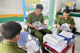 Lực lượng công an kiểm tra tại trụ sở chính của Công ty F88 ở địa chỉ 414, Quốc lộ 91, thị trấn Cái Dầu, huyện Châu Phú, tỉnh An Giang. (Ảnh: Công Mạo/TTXVN)