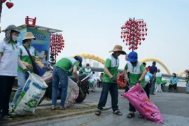 Thanh niên, người dân tham gia nhặt rác dọc ven sông Hàn (đường Trần Hưng Đạo, quận Sơn Trà, Đà Nẵng). (Ảnh: Văn Dũng/TTXVN)