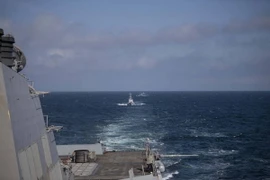 Tàu của hải quân Ukraine đi qua tàu khu trục USS Roosevelt (DDG 80) trong một cuộc tập trận trên Biển Đen. (Ảnh: AFP/TTXVN)