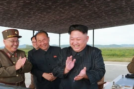 Nhà lãnh đạo Triều Tiên Kim Jong-un (phải) kiểm tra vụ phóng tên lửa Hwasong-12 tại một địa điểm ở Triều Tiên. (Nguồn: YONHAP/TTXVN)