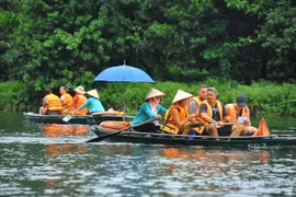 Du khách trong và ngoài nước tham quan khu du lịch Tràng An (Ninh Bình). (Ảnh: Minh Đức/TTXVN)