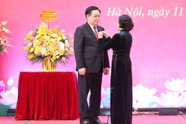 Bà Trương Thị Mai, Ủy viên Bộ Chính trị, Thường trực Ban Bí thư, Trưởng Ban Tổ chức Trung ương trao Huy hiệu 40 năm tuổi Đảng tặng Chủ tịch Quốc hội Vương Đình Huệ. (Ảnh: Nhan Sáng/TTXVN)