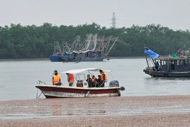 Lãnh đạo Thị xã Quảng Yên phối hợp với các lực lượng nỗ lực tìm kiếm nạn nhân mất tích trên sông Chanh. (Ảnh: TTXVN phát)