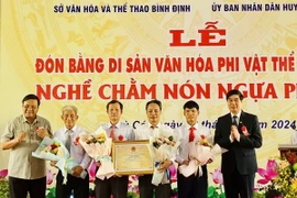 Trao Bằng chứng nhận di sản văn hóa phi vật thể Quốc gia "Nghề chằm nón ngựa Phú Gia" cho Đảng bộ, chính quyền huyện Phù Cát. (Ảnh: TTXVN phát)