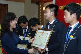 Em Đinh Lê Công nhận bằng khen. (Ảnh: Quý Trung/TTXVN)