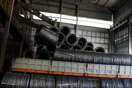 Bốc xếp sản phẩm thép cuộn. (Ảnh: Trọng Đạt/TTXVN)