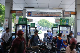 Nhân viên Petrolimex đang bán xăng cho khách hàng (Ảnh: PV/Vietnam+)