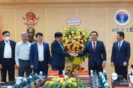Trưởng Ban Tuyên giáo Trung ương Nguyễn Trọng Nghĩa tặng hoa chúc mừng cán bộ, nhân viên Bộ Y tế. (Ảnh: Phương Hoa/TTXVN)