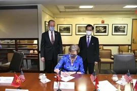 Đại sứ Hà Kim Ngọc và Trợ lý Ngoại trưởng Stilwell chứng kiến Giám đốc Chương trình Hòa bình Jody Olsen ký văn bản cam kết sẽ ký Thỏa thuận triển khai Chương trình Hòa bình. (Ảnh: TTXVN)