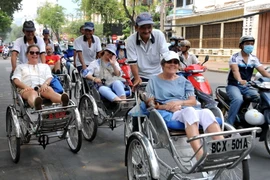 Du khách quốc tế tham quan Thành phố Hồ Chí Minh. (Nguồn: TTXVN)