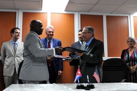 Hai bên trao đổi Bản ghi nhớ hợp tác sau lễ ký. (Ảnh: Lê Hà/TTXVN)