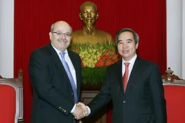 Trưởng Ban Kinh tế Trung ương Nguyễn Văn Bình và đại diện Đoàn chuyên gia IMF, ông Alex Moumouras. (Ảnh: Nguyễn Dân/TTXVN)