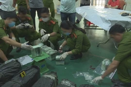 Lực lượng chức năng kiểm đếm số ma túy. (Ảnh: TTXVN phát)