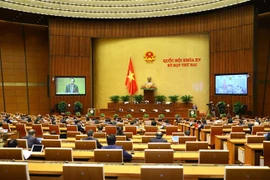 Bộ trưởng Bộ Lao động, Thương binh - Xã hội Đào Ngọc Dung trình bày Báo cáo tình hình thực hiện chính sách, chế độ bảo hiểm xã hội, quản lý và sử dụng Quỹ bảo hiểm xã hội năm 2020. (Ảnh: Văn Điệp/TTXVN)