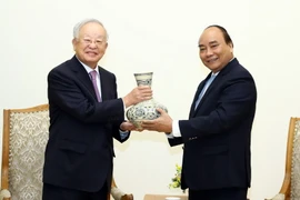 Thủ tướng Nguyễn Xuân Phúc tặng quà lưu niệm cho ông Sohn Kyung Shik, Chủ tịch Tập đoàn CJ (Hàn Quốc). (Ảnh: Thống Nhất/TTXVN)