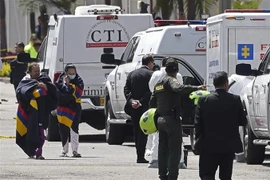 Sơ tán người dân khỏi hiện trường vụ nổ xe bom bên ngoài trường cảnh sát ở thủ đô Bogota của Colombia ngày 17/1. (Ảnh: AFP/TTXVN)