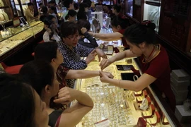 Khách giao dịch vàng tại Công ty vàng Bảo Tín Minh Châu (Hà Nội). (Ảnh: Trần Việt/TTXVN)