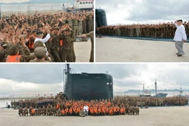 Nhà lãnh đạo Kim Jong-Un (phải- phía trên) và các binh sỹ Triều Tiên mừng thành công vụ phóng thử tên lửa đạn đạo Pukguksong từ tàu ngầm ngày 25/8. (Nguồn: YONHAP/TTXVN)