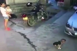 Người phụ nữ thản nhiên nhìn em bé bị xe ôtô chèn qua 