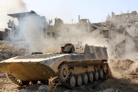 Lực lượng Chính phủ Syria tiến vào thị trấn Qabun ngày 13/5. AFP/TTXVN