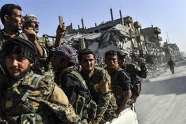 Các thành viên Lực lượng Dân chủ Syria sau chiến dịch truy quét các tay súng Tổ chức Nhà nước Hồi giáo (IS) tự xưng tại thành phố Raqa, miền Bắc Syria ngày 20/10/2017. (Nguồn: AFP/TTXVN) 