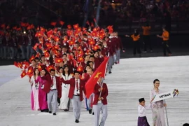 Đoàn thể thao Việt Nam diễu hành tại lễ khai mạc SEA Games ở Kuala Lumpur ngày 19/8. (Nguồn: AFP/TTXVN)