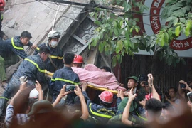 Nạn nhân cuối cùng trong căn nhà sập tại Cửa Bắc được cứu thoát ra ngoài. (Ảnh: Minh Sơn/Vietnam+)