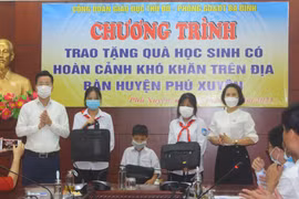 Em Dương Hà Trang (thứ hai từ bên phải sang) và các học sinh có hoàn cảnh khó khăn của huyện Phú Xuyên nhận quà tặng của Phòng Giáo dục và Đào tạo quận Ba Đình. (Ảnh: CTV)