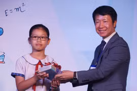 Đại diện Ban tổ chức trao tặng sách cho học sinh. (Ảnh: Thu Hoài/TTXVN)
