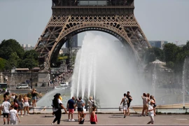 Người dân giải nhiệt tránh nóng tại một đài phun nước ở Paris, Pháp ngày 29/6/2019. (Nguồn: AFP/TTXVN)